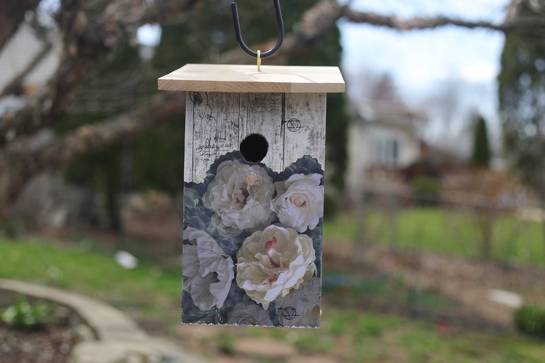 Do you hear French music? Beautiful old-fashioned roses and weathered painted wood decoupaged on cream colored background with stamped lettering. Made of weather and insect resistant cedar, wood glue, polyacrylic sealed, easy bottom cleanout and ready to hang. 6 1/2" L x 5 3/8" W x 12 1/2" H.